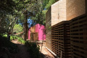 Brick and wood houses with pink coloured walls