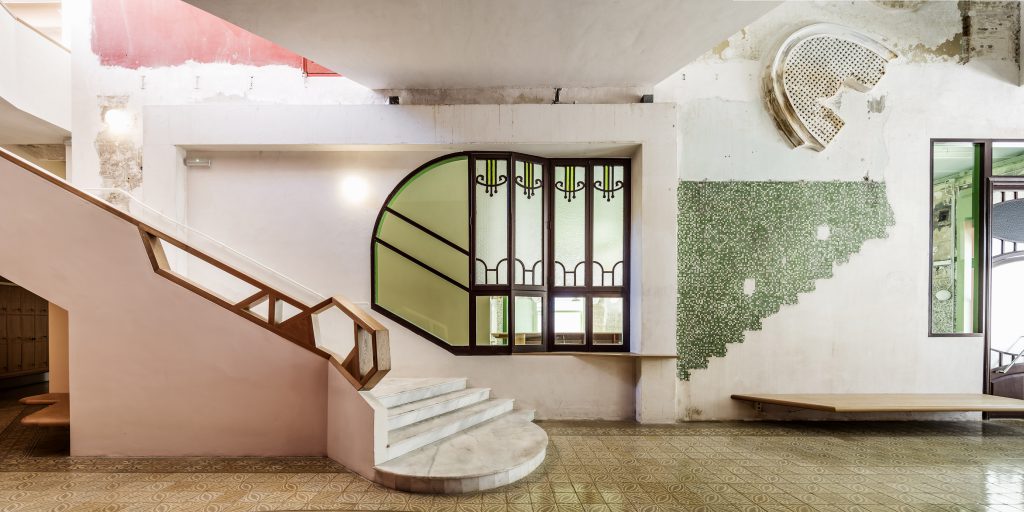 Interior with stone staircase and green and pink wall painting