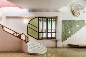 Interior with stone staircase and green and pink wall painting