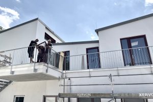 3 men working on a railing