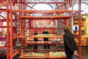 Red scaffolding with man in front of it