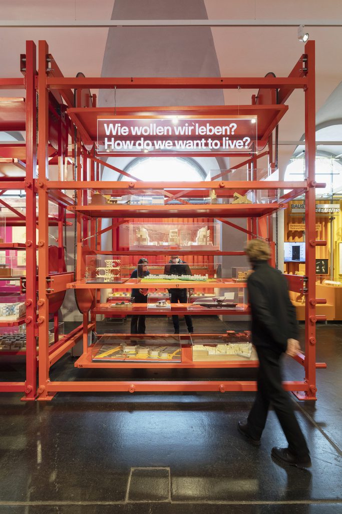 Red scaffolding with man in front of it