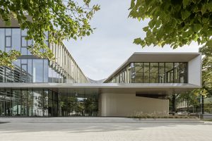 2-wing building with green leaves in front