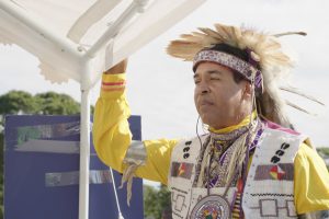 Man with feather headdress and colourful robe