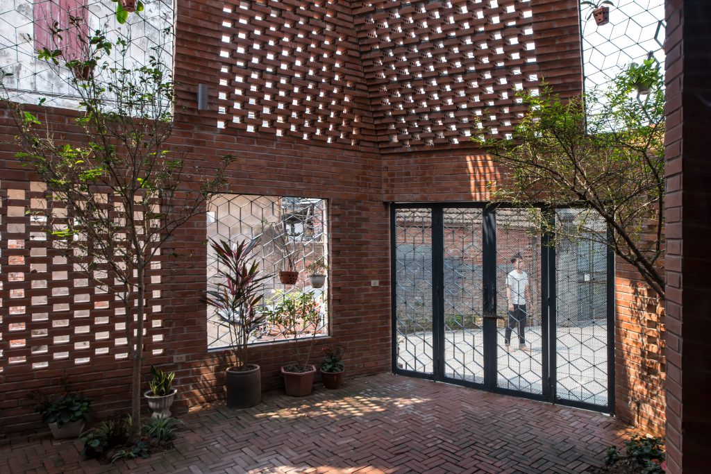 Interior of a building made of bricks with some plants