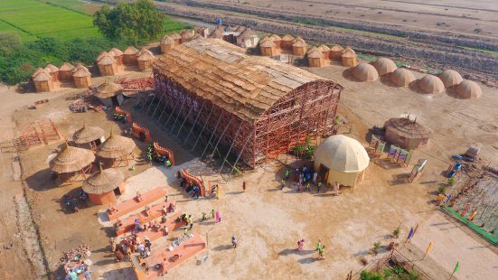 Hall made of bamboo with many smaller huts around it