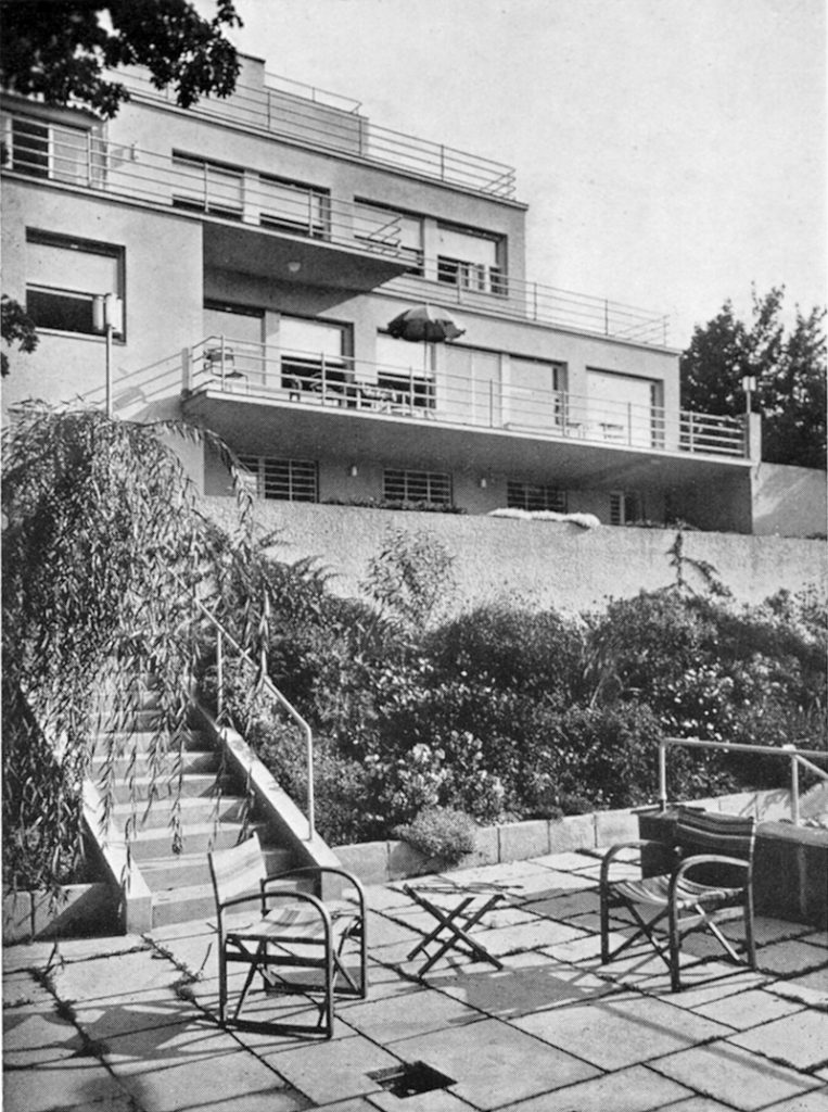 black and white shot of a large house lined with terraces