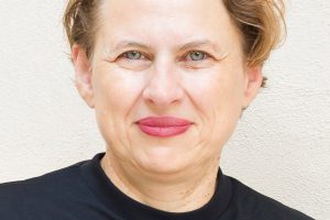 Woman with short hair and black shirt