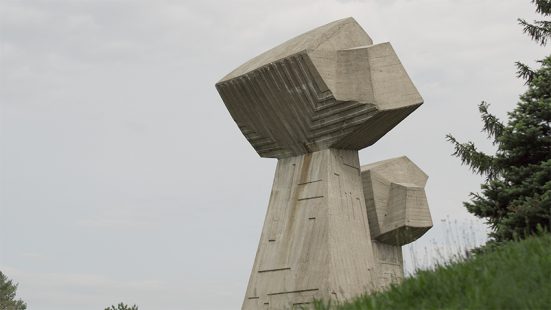 Large concrete sculpture in a meadow