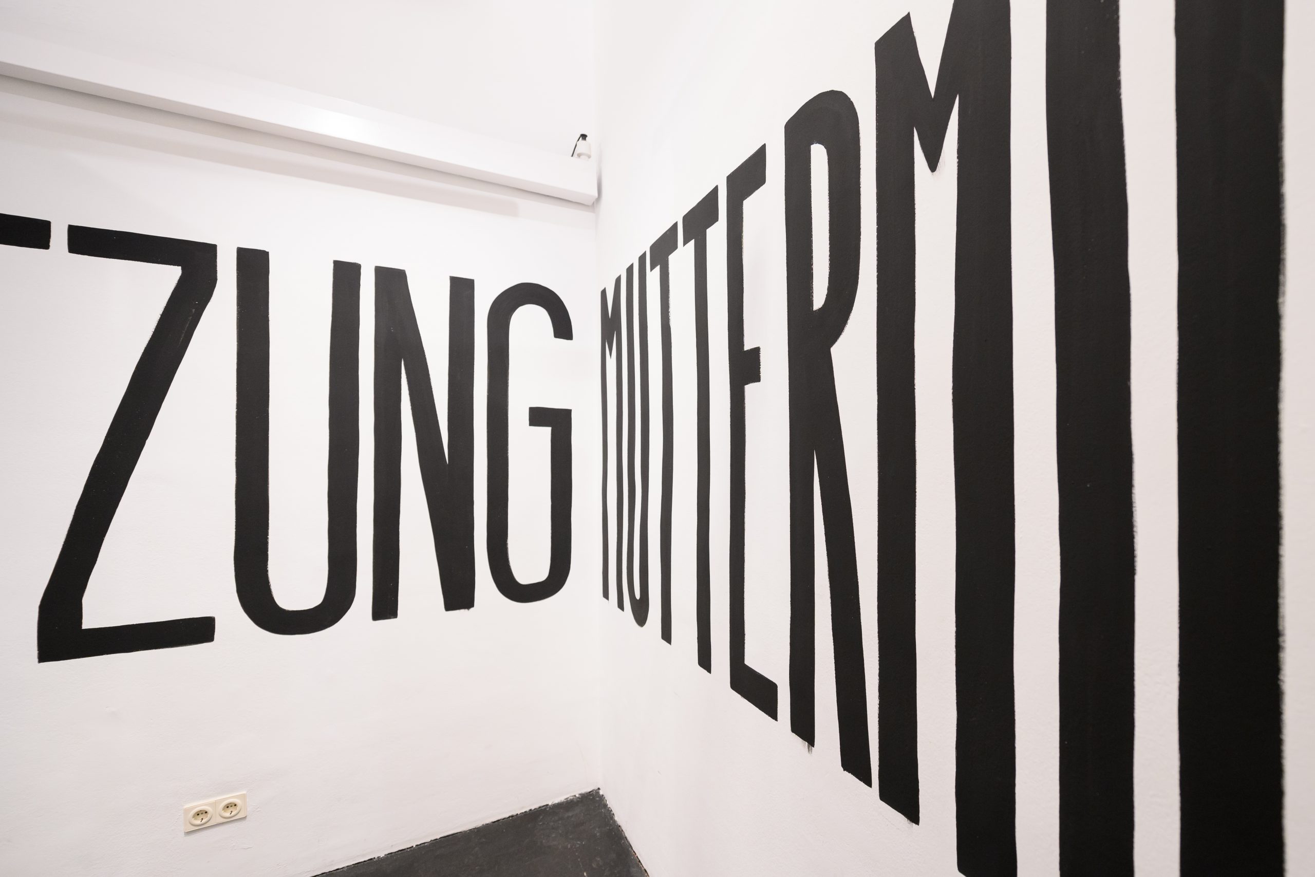 large black letters painted on a white wall