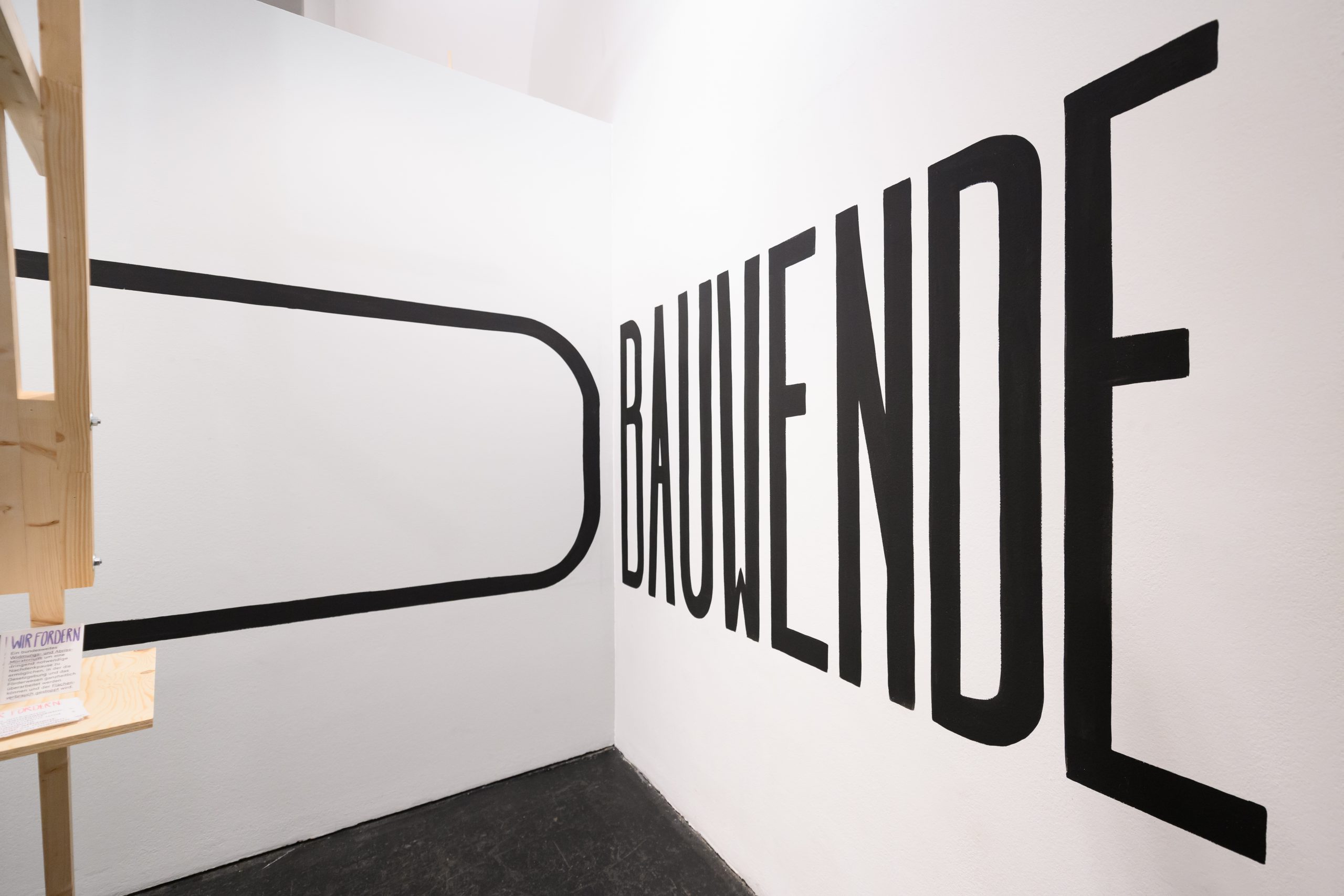 the word Bauwende is written in large black letters on a white wall