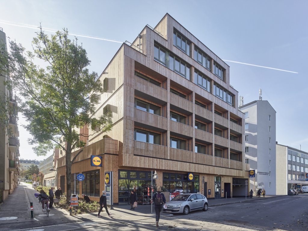 Multi-storey building in timber construction, with a supermarket on the ground floor