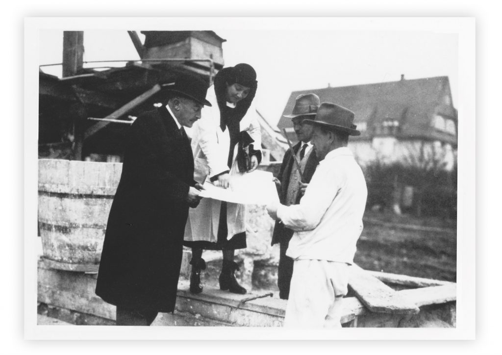 black and white photo with 3 men in hats and a woman in a hat