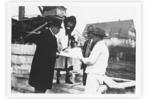 black and white photo with 3 men in hats and a woman in a hat