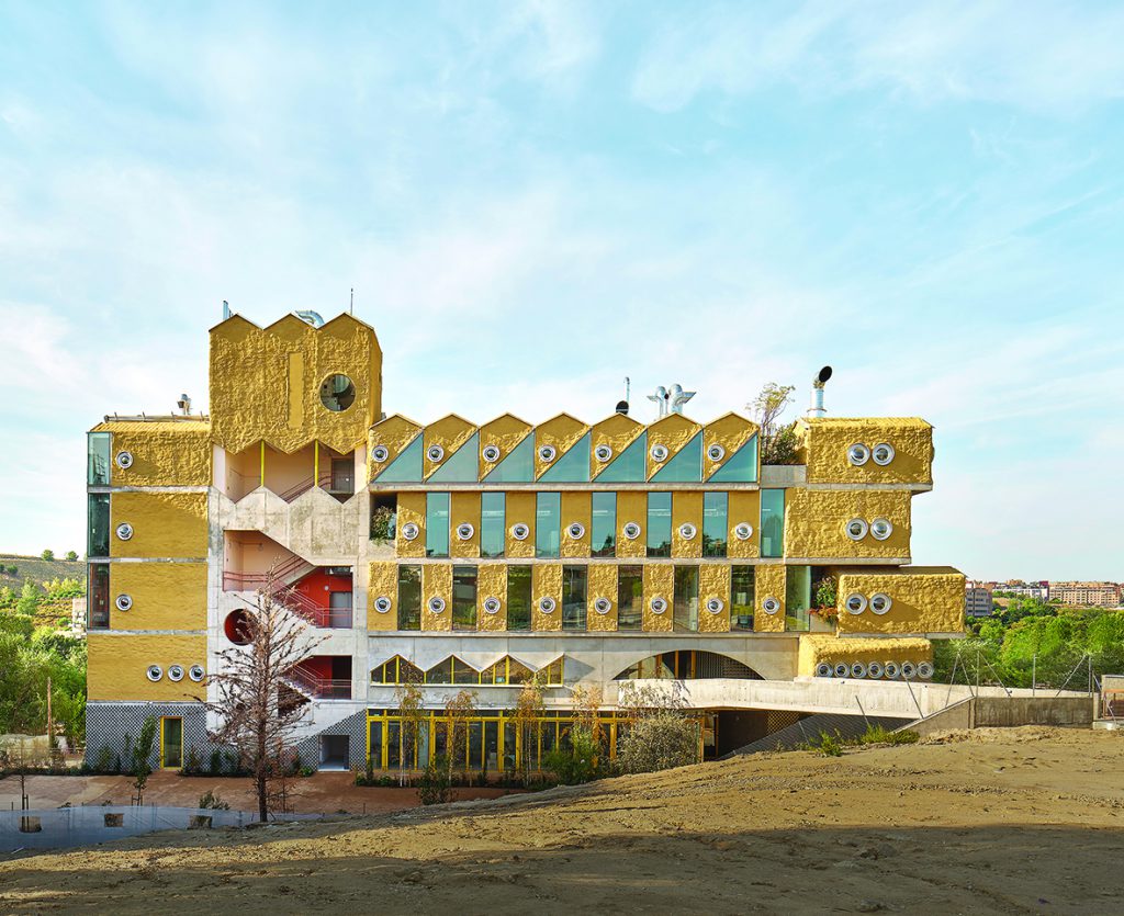 Building in ochre yellow with small porthole windows