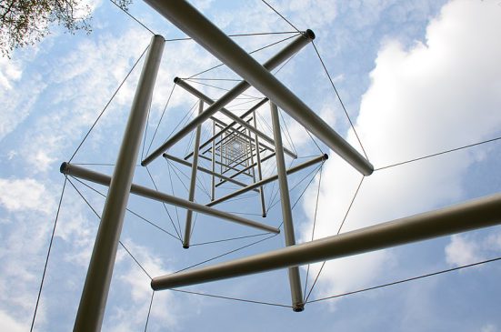 ropes with poles hanging in the air, above them the sky with clouds