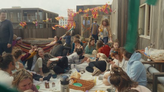 many people sit and lie around and have a picnic