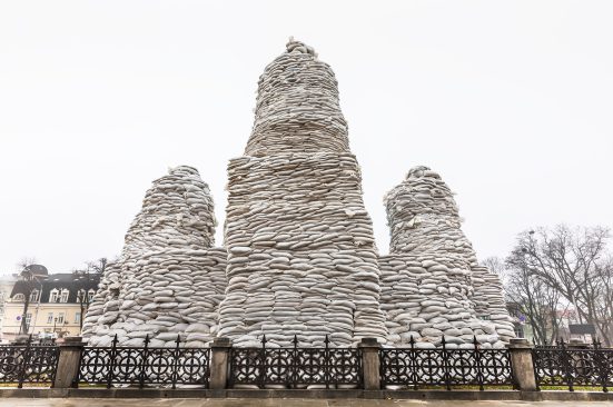 Three towers standing side by side, all covered with sandbags.