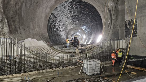 Construction site in a massive tunnel with construction workers