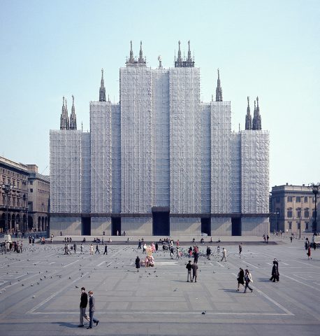 A very large building with several towers of varying heights, completely enclosed on the outside. Only the tops of the towers protrude.