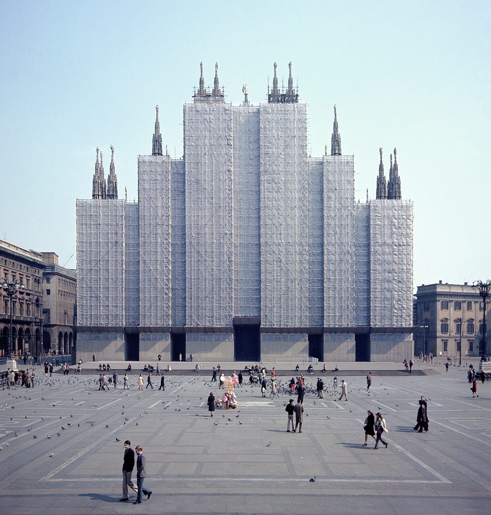 A very large building with several towers of varying heights, completely enclosed on the outside. Only the tops of the towers protrude.